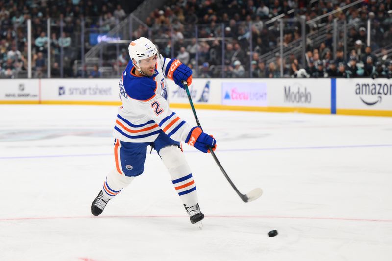 Oct 2, 2024; Seattle, Washington, USA; Edmonton Oilers defenseman Evan Bouchard (2) shoots a goal shot against the Seattle Kraken during the second period at Climate Pledge Arena. Mandatory Credit: Steven Bisig-Imagn Images