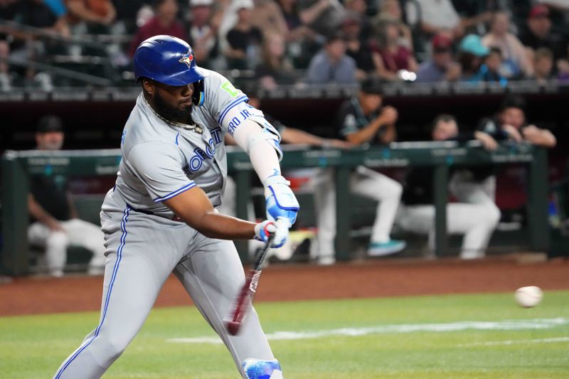 Jul 12, 2024; Phoenix, Arizona, USA; Toronto Blue Jays first base Vladimir Guerrero Jr. (27) hits a single against the Arizona Diamondbacks during the first inning at Chase Field. Mandatory Credit: Joe Camporeale-USA TODAY Sports