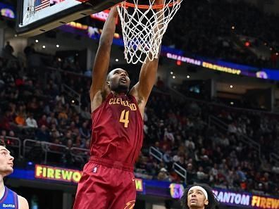 CLEVELAND, OHIO - NOVEMBER 19: Evan Mobley #4 of the Cleveland Cavaliers dunks over Zeke Nnaji #22 of the Denver Nuggets during the fourth quarter at Rocket Mortgage Fieldhouse on November 19, 2023 in Cleveland, Ohio. The Cavaliers defeated the Nuggets 121-109. NOTE TO USER: User expressly acknowledges and agrees that, by downloading and or using this photograph, User is consenting to the terms and conditions of the Getty Images License Agreement. (Photo by Jason Miller/Getty Images)