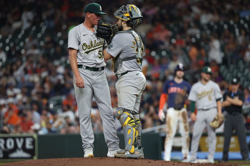 May 15, 2024; Houston, Texas, USA;  Oakland Athletics catcher Shea Langeliers (23) talks with pitcher Aaron Brooks (53) on the mound before pitching against Houston Astros designated hitter Yordan Alvarez (44) in the fifth inning at Minute Maid Park. Mandatory Credit: Thomas Shea-USA TODAY Sports