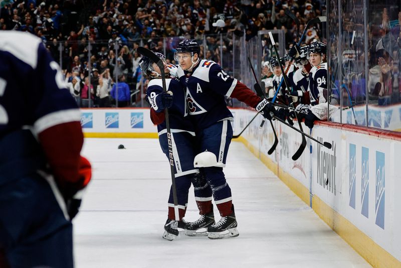 Apr 9, 2024; Denver, Colorado, USA; Colorado Avalanche center Nathan MacKinnon (29) celebrates his hat trick goal with defenseman Samuel Girard (49) in the second period against the Minnesota Wild at Ball Arena. Mandatory Credit: Isaiah J. Downing-USA TODAY Sports