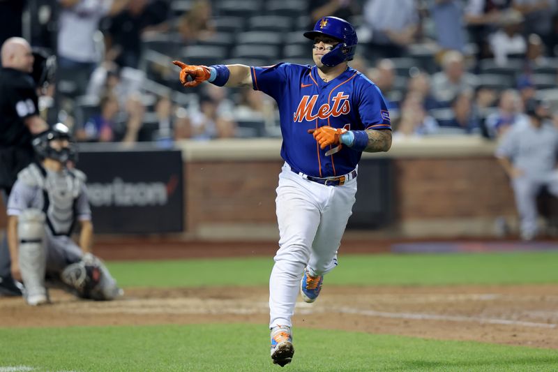 Jul 18, 2023; New York City, New York, USA; New York Mets catcher Francisco Alvarez (4) points into the dugout as he rounds the bases after hitting a two run home run against the Chicago White Sox during the sixth inning at Citi Field. Mandatory Credit: Brad Penner-USA TODAY Sports