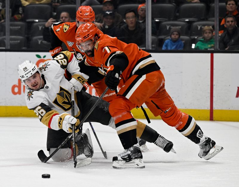 Dec 4, 2024; Anaheim, California, USA; Vegas Golden Knights right wing Alexander Holtz (26) shoots against Anaheim Ducks defenseman Radko Gudas (7) and defenseman Cam Fowler (4) during the first period at Honda Center. Mandatory Credit: Alex Gallardo-Imagn Images