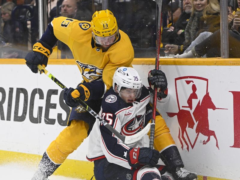 Jan 17, 2023; Nashville, Tennessee, USA;  Nashville Predators center Yakov Trenin (13) and Columbus Blue Jackets defenseman Tim Berni (75) fight for the puck during the third period at Bridgestone Arena. Mandatory Credit: Steve Roberts-USA TODAY Sports