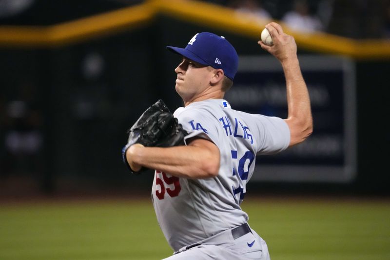 Aug 8, 2023; Phoenix, Arizona, USA; Los Angeles Dodgers relief pitcher Evan Phillips (59) pitches against the Arizona Diamondbacks during the ninth inning at Chase Field. Mandatory Credit: Joe Camporeale-USA TODAY Sports