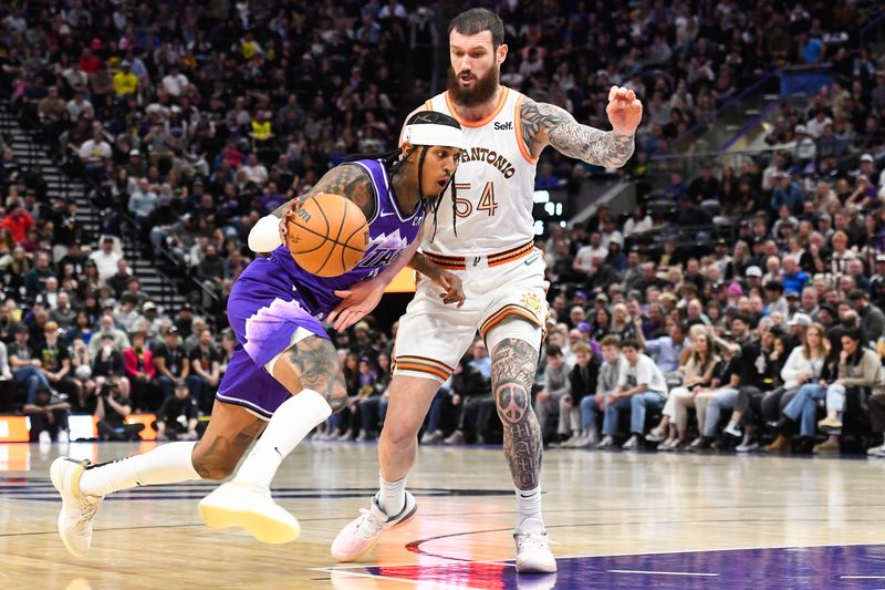 SALT LAKE CITY, UTAH - FEBRUARY 25: Jordan Clarkson #00 of the Utah Jazz drives against Sandro Mamukelashvili #54 of the San Antonio Spurs during the second half at Delta Center on February 25, 2024 in Salt Lake City, Utah. NOTE TO USER: User expressly acknowledges and agrees that, by downloading and or using this photograph, User is consenting to the terms and conditions of the Getty Images License Agreement. (Photo by Alex Goodlett/Getty Images)