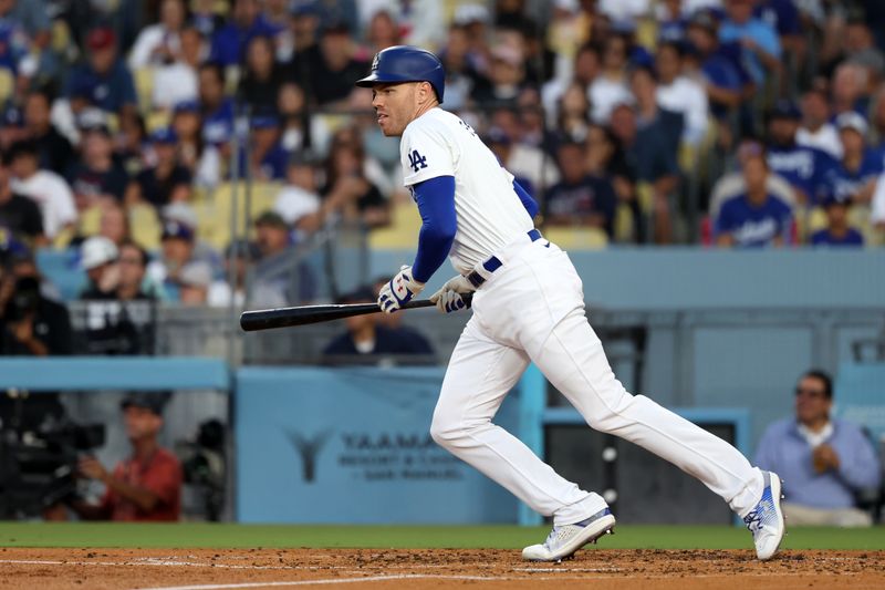 Jul 2, 2024; Los Angeles, California, USA;  Los Angeles Dodgers first baseman Freddie Freeman (5) hits an RBI single during the third inning against the Arizona Diamondbacks at Dodger Stadium. Mandatory Credit: Kiyoshi Mio-USA TODAY Sports