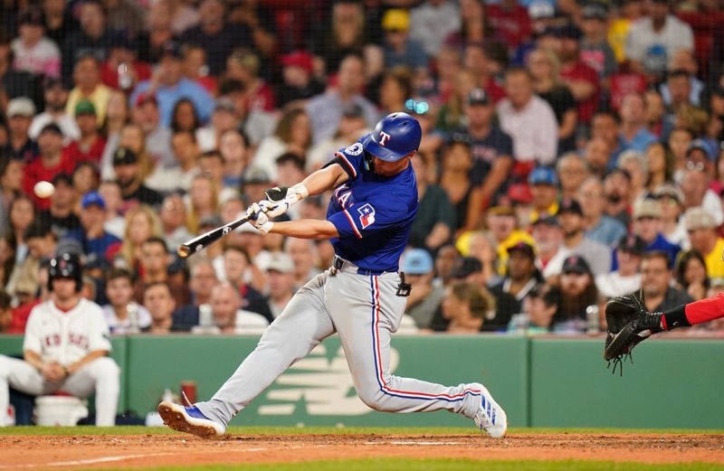 Aug 12, 2024; Boston, Massachusetts, USA; Texas Rangers shortstop Corey Seager (5) hits a two run home run against the Boston Red Sox in the seventh inning at Fenway Park. Mandatory Credit: David Butler II-USA TODAY Sports