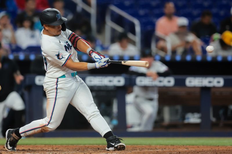 Jun 4, 2025; Miami, Florida, USA; Miami Marlins left fielder Heriberto Hernandez (64) hits an RBI single against the Colorado Rockies during the seventh inning at loanDepot Park. Mandatory Credit: Sam Navarro-Imagn Images