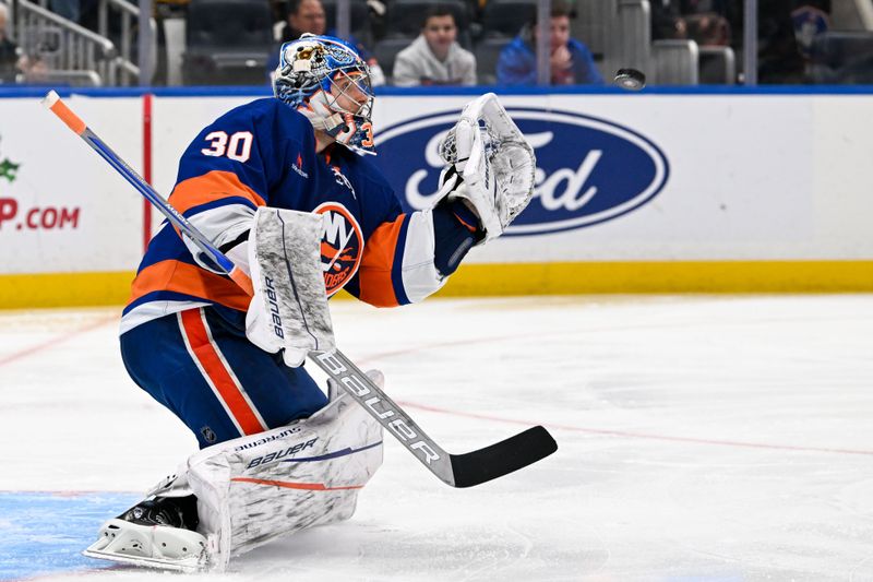 Nov 27, 2024; Elmont, New York, USA;  New York Islanders goaltender Ilya Sorokin (30) makes a glove save during the third period at UBS Arena. Mandatory Credit: Dennis Schneidler-Imagn Images