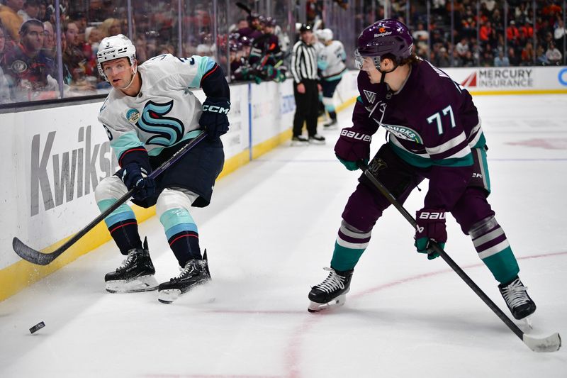 Dec 23, 2023; Anaheim, California, USA; Seattle Kraken defenseman Will Borgen (3) moves the puck against Anaheim Ducks right wing Frank Vatrano (77) during the third period at Honda Center. Mandatory Credit: Gary A. Vasquez-USA TODAY Sports