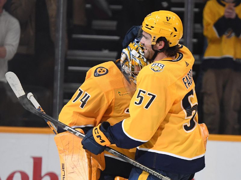 Feb 27, 2024; Nashville, Tennessee, USA; Nashville Predators goaltender Juuse Saros (74) celebrates with defenseman Dante Fabbro (57) after a win against the Ottawa Senators at Bridgestone Arena. Mandatory Credit: Christopher Hanewinckel-USA TODAY Sports