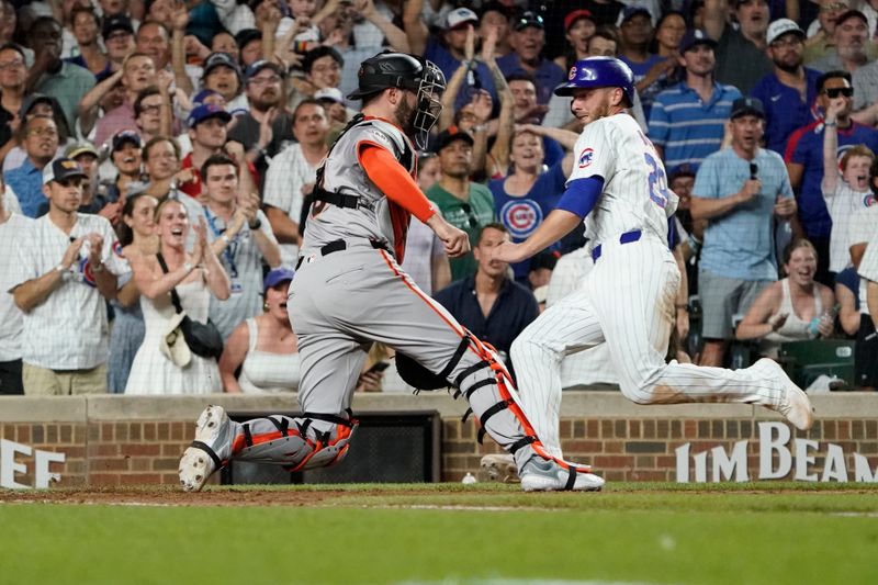 Jun 18, 2024; Chicago, Illinois, USA; Chicago Cubs first base Michael Busch (29) is safe at home plate as San Francisco Giants catcher Curt Casali (18) makes a late tag during the eighth inning at Wrigley Field. Mandatory Credit: David Banks-USA TODAY Sports