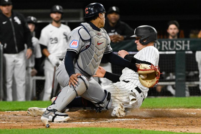 May 11, 2024; Chicago, Illinois, USA;  Chicago White Sox first base Andrew Vaughn (25) scores against Cleveland Guardians catcher Bo Naylor (23) during the eighth inning at Guaranteed Rate Field. Mandatory Credit: Matt Marton-USA TODAY Sports