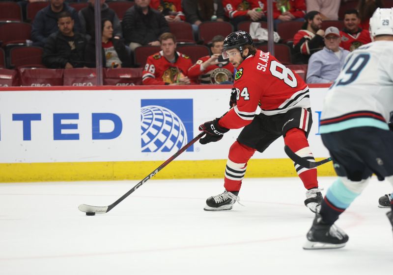 Mar 18, 2025; Chicago, Illinois, USA; Chicago Blackhawks left wing Landon Slaggert (84) skates with the puck during the third period against the Seattle Kraken at United Center. Mandatory Credit: Talia Sprague-Imagn Images