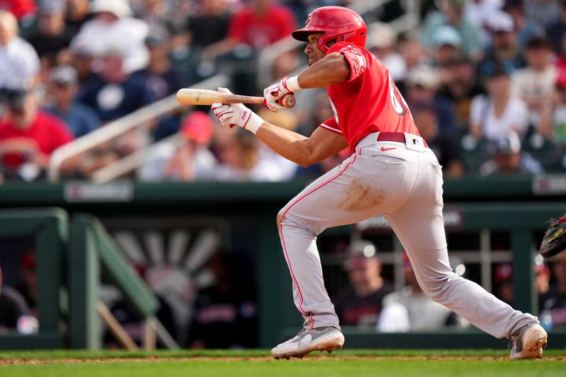 Feb. 24, 2024; Goodyear, Arizona, USA; Cincinnati Reds outfielder Bubba Thompson squares up to bunt in the eighth inning during a MLB spring training baseball game against the Cleveland Guardians at Goodyear Ballpark. Mandatory Credit: Kareem Elgazzar-USA TODAY Sports