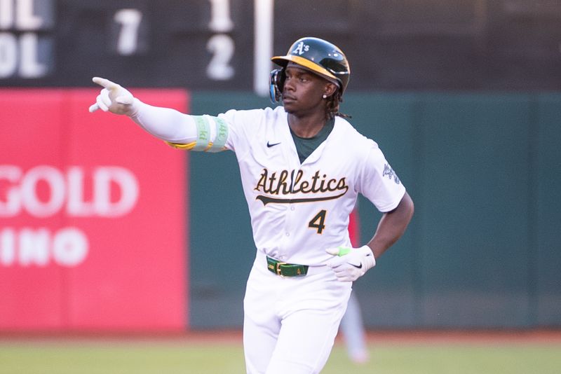 Jul 2, 2024; Oakland, California, USA; Oakland Athletics outfielder Lawrence Butler (4) points to the crowd after hitting a home run against the Los Angeles Angels during the fourth inning at Oakland-Alameda County Coliseum. Mandatory Credit: Ed Szczepanski-USA TODAY Sports