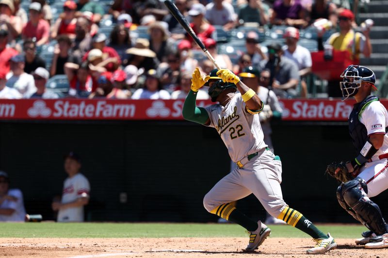 Jul 28, 2024; Anaheim, California, USA;  Oakland Athletics left fielder Miguel Andujar (22) hits an RBI fielder's choice during the third inning against the Los Angeles Angels at Angel Stadium. Mandatory Credit: Kiyoshi Mio-USA TODAY Sports