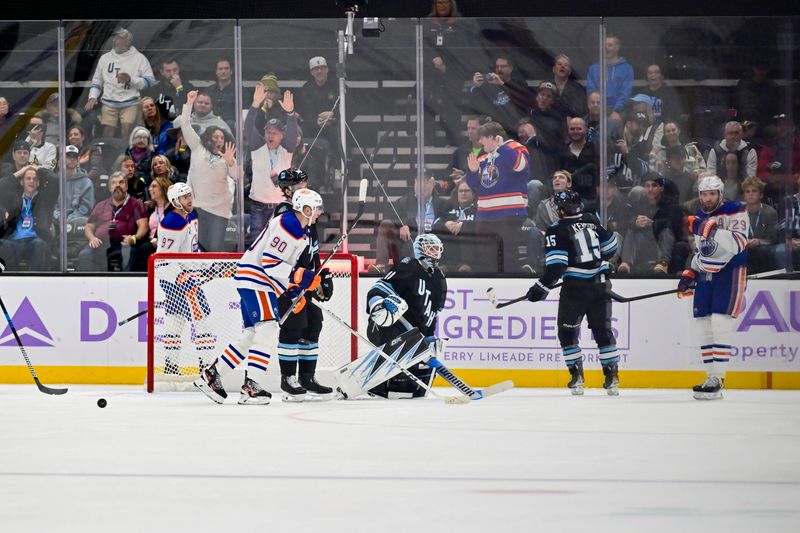 Nov 29, 2024; Salt Lake City, Utah, USA; Edmonton Oilers center Leon Draisaitl (29) scores past Utah Hockey Club goaltender Karel Vejmelka (70) during the second period at the Delta Center. Mandatory Credit: Christopher Creveling-Imagn Images