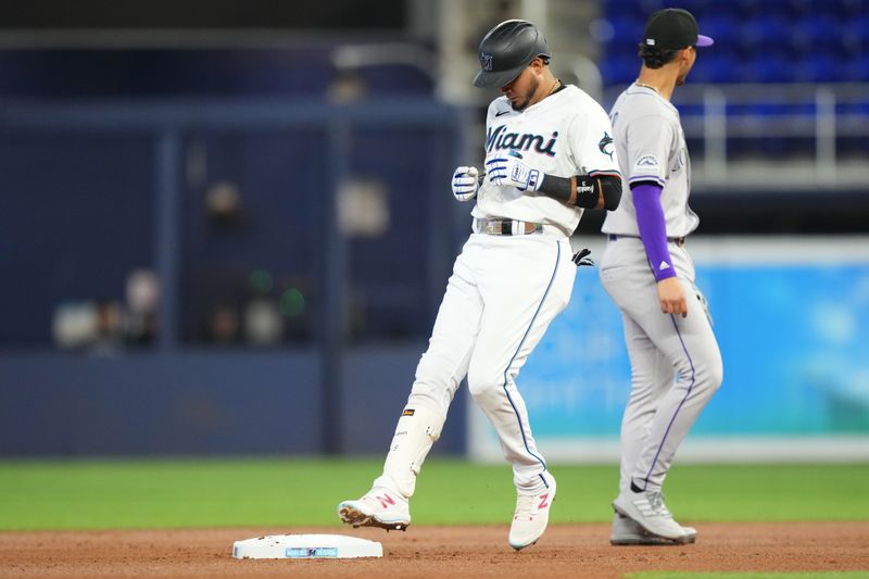 May 2, 2024; Miami, Florida, USA;  Miami Marlins second baseman Luis Arraez (3) hits a double in the first inning against the Colorado Rockies at loanDepot Park. Mandatory Credit: Jim Rassol-USA TODAY Sports