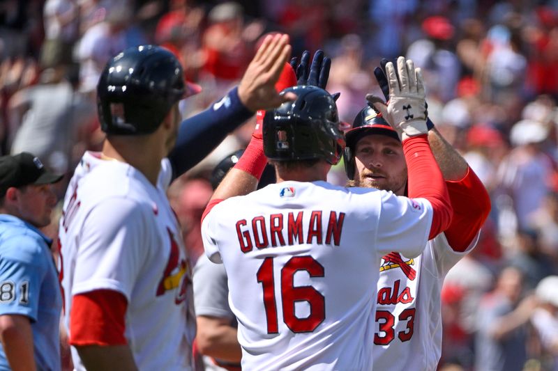 May 7, 2023; St. Louis, Missouri, USA;  St. Louis Cardinals left fielder Brendan Donovan (33) is congratulated by second baseman Nolan Gorman (16) and third baseman Nolan Arenado (28) after hitting a three run home run against the Detroit Tigers during the sixth inning at Busch Stadium. Mandatory Credit: Jeff Curry-USA TODAY Sports