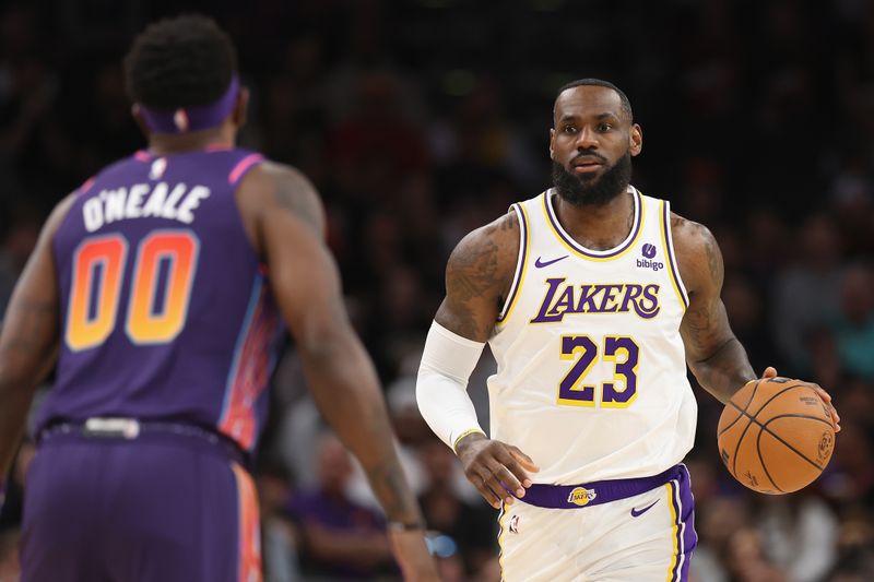 PHOENIX, ARIZONA - FEBRUARY 25: LeBron James #23 of the Los Angeles Lakers handles the ball against the Phoenix Suns during the first half of the NBA game at Footprint Center on February 25, 2024 in Phoenix, Arizona. NOTE TO USER: User expressly acknowledges and agrees that, by downloading and or using this photograph, User is consenting to the terms and conditions of the Getty Images License Agreement.  (Photo by Christian Petersen/Getty Images)