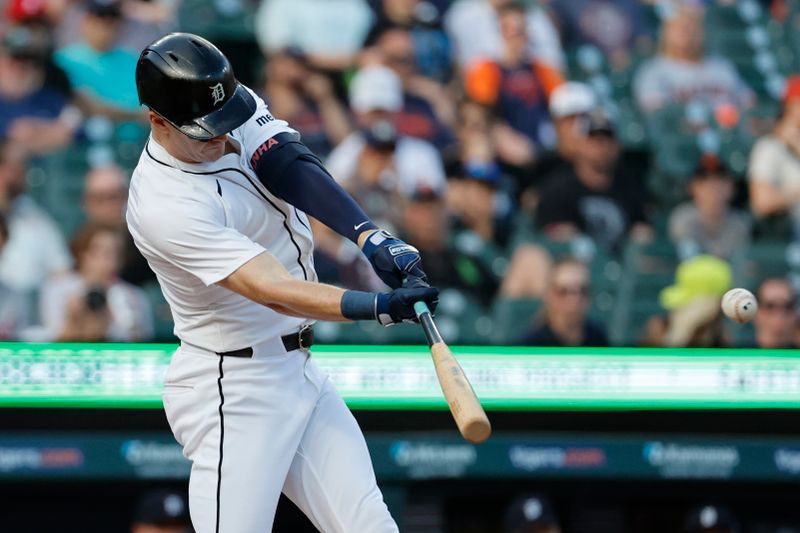 Jun 12, 2024; Detroit, Michigan, USA;  Detroit Tigers left fielder Mark Canha (21) hits a single in the first inning against the Washington Nationals at Comerica Park. Mandatory Credit: Rick Osentoski-USA TODAY Sports