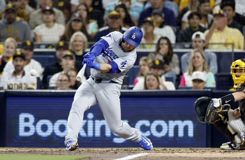 Oct 9, 2024; San Diego, California, USA; Los Angeles Dodgers third baseman Max Muncy (13) doubles in the third inning against the San Diego Padres during game four of the NLDS for the 2024 MLB Playoffs at Petco Park.  Mandatory Credit: Denis Poroy-Imagn Images