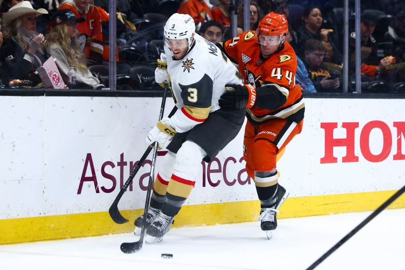 Nov 13, 2024; Anaheim, California, USA; Vegas Golden Knights defenseman Brayden McNabb (3) and Anaheim Ducks left wing Ross Johnston (44) battle for the puck during the second period of a hockey game at Honda Center. Mandatory Credit: Jessica Alcheh-Imagn Images