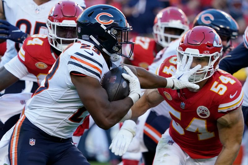 Chicago Bears running back Roschon Johnson (23) runs with the ball as Kansas City Chiefs linebacker Leo Chenal (54) defends during the second half of an NFL football game Sunday, Sept. 24, 2023, in Kansas City, Mo. (AP Photo/Ed Zurga)