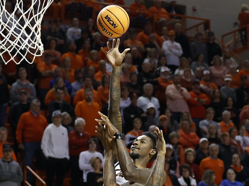 Feb 14, 2023; Stillwater, Oklahoma, USA; Oklahoma State Cowboys forward Kalib Boone (22) shoots as Kansas Jayhawks forward K.J. Adams Jr. (24) defends the shot during the first half at Gallagher-Iba Arena. Mandatory Credit: Alonzo Adams-USA TODAY Sports