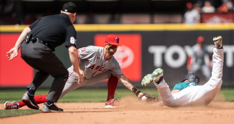 Jul 24, 2024; Seattle, Washington, USA;  Seattle Mariners left fielder Luke Raley (20) steals second base ahead of a tag by Los Angeles Angels shortstop s9n during the seventh inning at T-Mobile Park. Mandatory Credit: Stephen Brashear-USA TODAY Sports