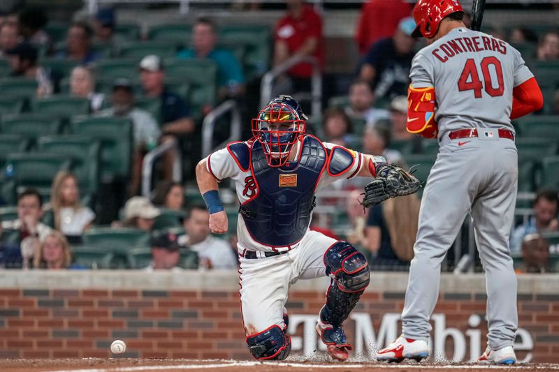 Sep 6, 2023; Cumberland, Georgia, USA; Atlanta Braves catcher Sean Murphy (12) chases the ball after blocking a low pitch against the St. Louis Cardinals during the second inning at Truist Park. Mandatory Credit: Dale Zanine-USA TODAY Sports