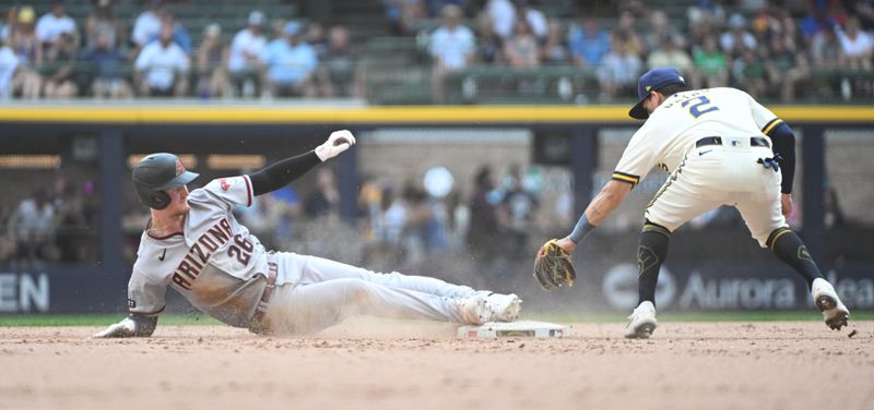 Jun 21, 2023; Milwaukee, Wisconsin, USA; Arizona Diamondbacks designated hitter Pavin Smith (26) slides in safely ahead of the tag by Milwaukee Brewers left fielder Raimel Tapia (3) in the eighth inning at American Family Field. Mandatory Credit: Michael McLoone-USA TODAY Sports