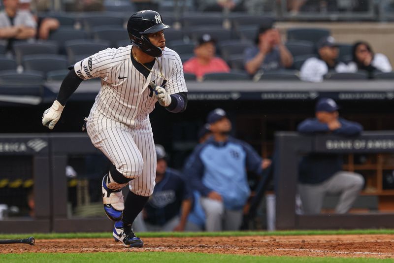 May 4, 2025; Bronx, New York, USA; New York Yankees second baseman Jorbit Vivas (90) hits a two RBI single during the eighth inning against the Tampa Bay Rays at Yankee Stadium. Mandatory Credit: Vincent Carchietta-Imagn Images