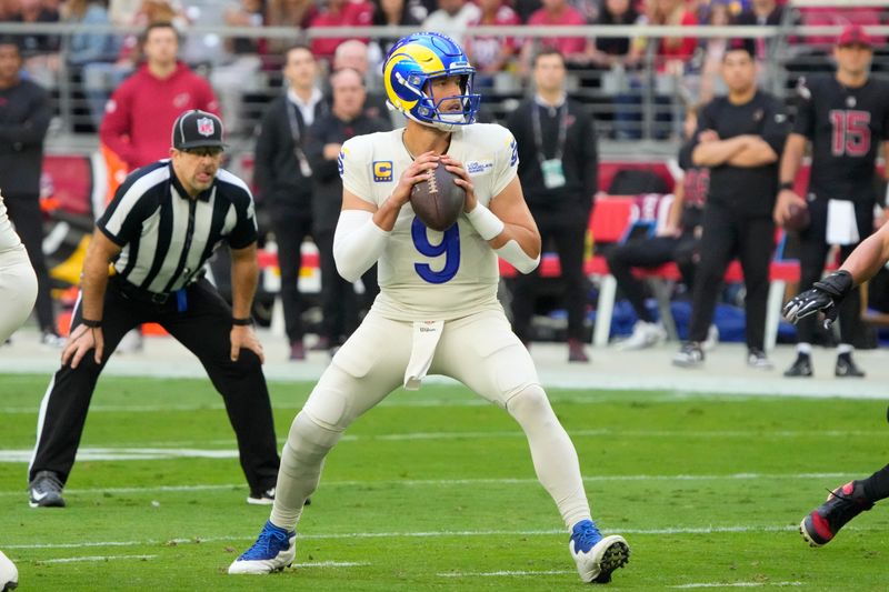 Los Angeles Rams quarterback Matthew Stafford (9) throws the football against the Arizona Cardinals during the first half of an NFL football game, Sunday, Nov. 26, 2023, in Glendale, Ariz. (AP Photo/Rick Scuteri)