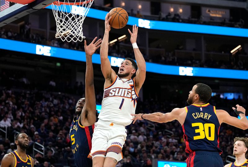 SAN FRANCISCO, CALIFORNIA - JANUARY 31: Devin Booker #1 of the Phoenix Suns shoots over Kevon Looney #5 of the Golden State Warriors during the second half at Chase Center on January 31, 2025 in San Francisco, California. NOTE TO USER: User expressly acknowledges and agrees that, by downloading and or using this photograph, User is consenting to the terms and conditions of the Getty Images License Agreement. (Photo by Thearon W. Henderson/Getty Images)