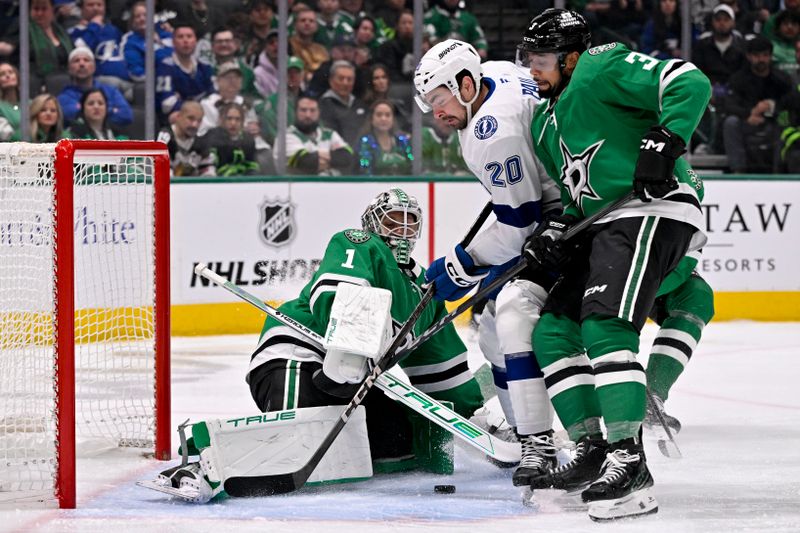 Mar 20, 2025; Dallas, Texas, USA; Dallas Stars goaltender Casey DeSmith (1) stops a shot by Tampa Bay Lightning left wing Nick Paul (20) during the first period at the American Airlines Center. Mandatory Credit: Jerome Miron-Imagn Images