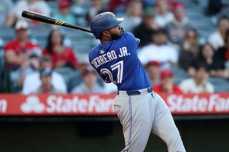 May 7, 2025; Anaheim, California, USA;  Toronto Blue Jays first baseman Vladimir Guerrero Jr. (27) hits a single during the first inning against the Los Angeles Angels at Angel Stadium. Mandatory Credit: Kiyoshi Mio-Imagn Images