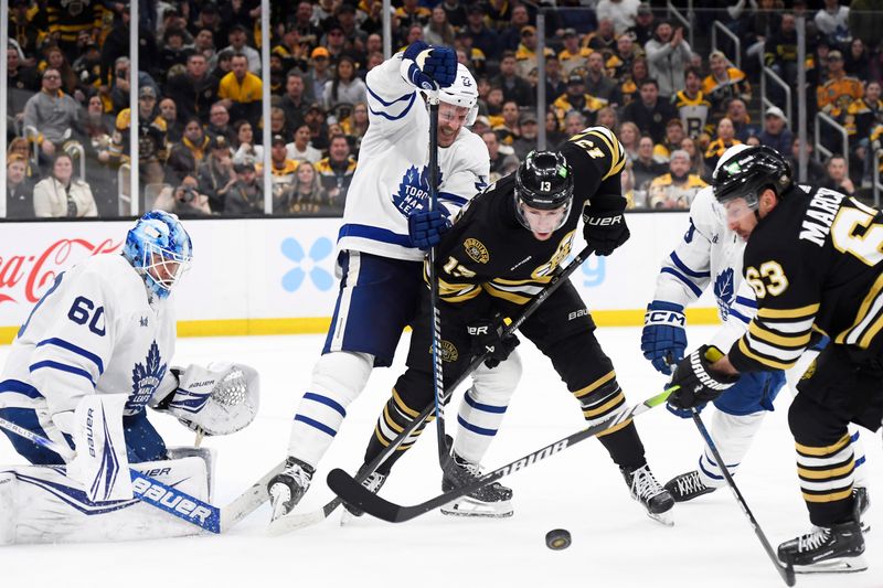 Apr 30, 2024; Boston, Massachusetts, USA; Toronto Maple Leafs defenseman Jake McCabe (22) ties up Boston Bruins center Charlie Coyle (13) in front of goaltender Joseph Woll (60) during the third period in game five of the first round of the 2024 Stanley Cup Playoffs at TD Garden. Mandatory Credit: Bob DeChiara-USA TODAY Sports