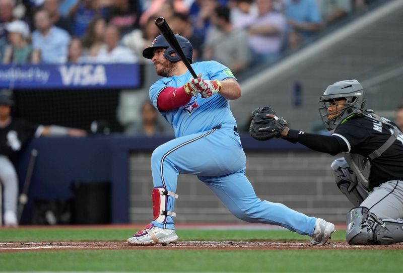 May 22, 2024; Toronto, Ontario, CAN; Toronto Blue Jays catcher Alejandro Kirk (30) hits a single against the Chicago White Sox during the second inning at Rogers Centre. Mandatory Credit: John E. Sokolowski-USA TODAY Sports