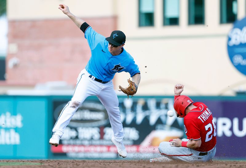 Mar 7, 2023; Jupiter, Florida, USA; Washington Nationals right fielder Lane Thomas (28) steals second base against Miami Marlins shortstop Joey Wendle (left) in the third inning at Roger Dean Stadium. Mandatory Credit: Rhona Wise-USA TODAY Sports