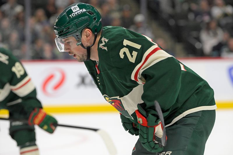 Mar 19, 2025; Saint Paul, Minnesota, USA;  Minnesota Wild forward Brendan Gaunce (21) lines up for a face-off against the Seattle Kraken during the second period at Xcel Energy Center. Mandatory Credit: Nick Wosika-Imagn Images
