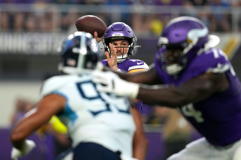 Minnesota Vikings quarterback Nick Mullens, center, throws a pass during the first half of an NFL football game against the Tennessee Titans, Saturday, Aug. 19, 2023, in Minneapolis. (AP Photo/Charlie Neibergall)