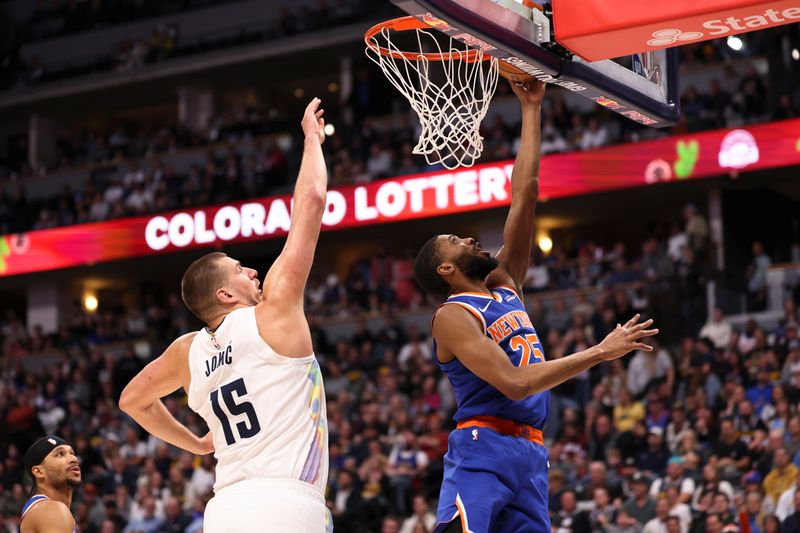 DENVER, COLORADO - NOVEMBER 25: Mikal Bridges #25 of the New York Knicks drives to the basket against Nikola Jokic #15 of the Denver Nuggets during the first half at Ball Arena on November 25, 2024 in Denver, Colorado. NOTE TO USER: User expressly acknowledges and agrees that, by downloading and/or using this Photograph, user is consenting to the terms and conditions of the Getty Images License Agreement. (Photo by Justin Tafoya/Getty Images)