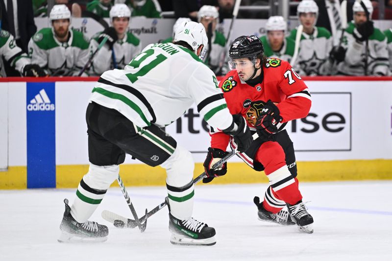 Jan 13, 2024; Chicago, Illinois, USA;  Chicago Blackhawks forward Cole Guttman (70) attempts to skate the puck around Dallas Stars forward Tyler Seguin (91) during a power play in the first period at United Center. Mandatory Credit: Jamie Sabau-USA TODAY Sports