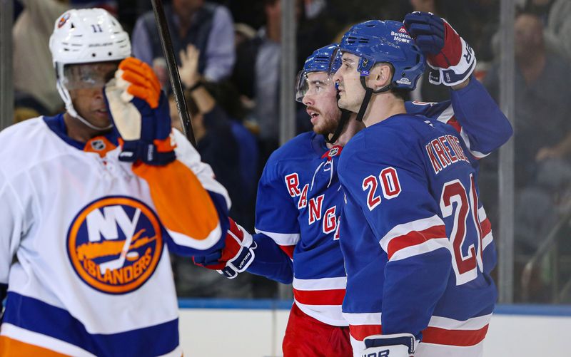 Sep 24, 2024; New York, New York, USA; New York Rangers right wing Reilly Smith (91) and left wing Chris Kreider (20) celebrate Kreider’s goal against the New York Islanders during the third period at Madison Square Garden. Mandatory Credit: Danny Wild-Imagn Images