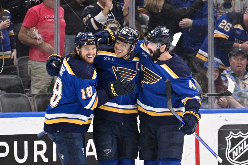 Apr 14, 2024; St. Louis, Missouri, USA; St. Louis Blues center Brayden Schenn (10) celebrates with center Robert Thomas (18) and defenseman Nick Leddy (4) after scoring a goal against the Seattle Kraken during the third period at Enterprise Center. Mandatory Credit: Jeff Le-USA TODAY Sports