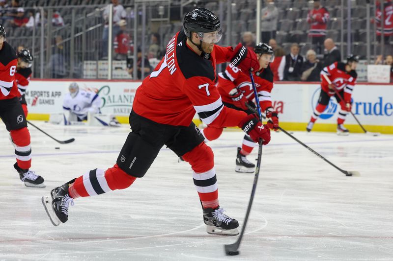 Oct 22, 2024; Newark, New Jersey, USA; New Jersey Devils defenseman Dougie Hamilton (7) shoots the puck during warmups before the game against the Tampa Bay Lightning at Prudential Center. Mandatory Credit: Ed Mulholland-Imagn Images