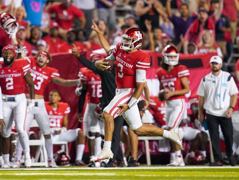 Sep 11, 2021; Houston, Texas, USA;  Houston Cougars quarterback Clayton Tune (3) grabs his leg during a long run in the second half against the Rice Owls at Rice Stadium. Mandatory Credit: Daniel Dunn-USA TODAY Sports